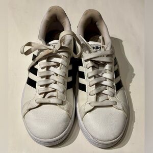 white Adidas sneakers in a women’s size 7.